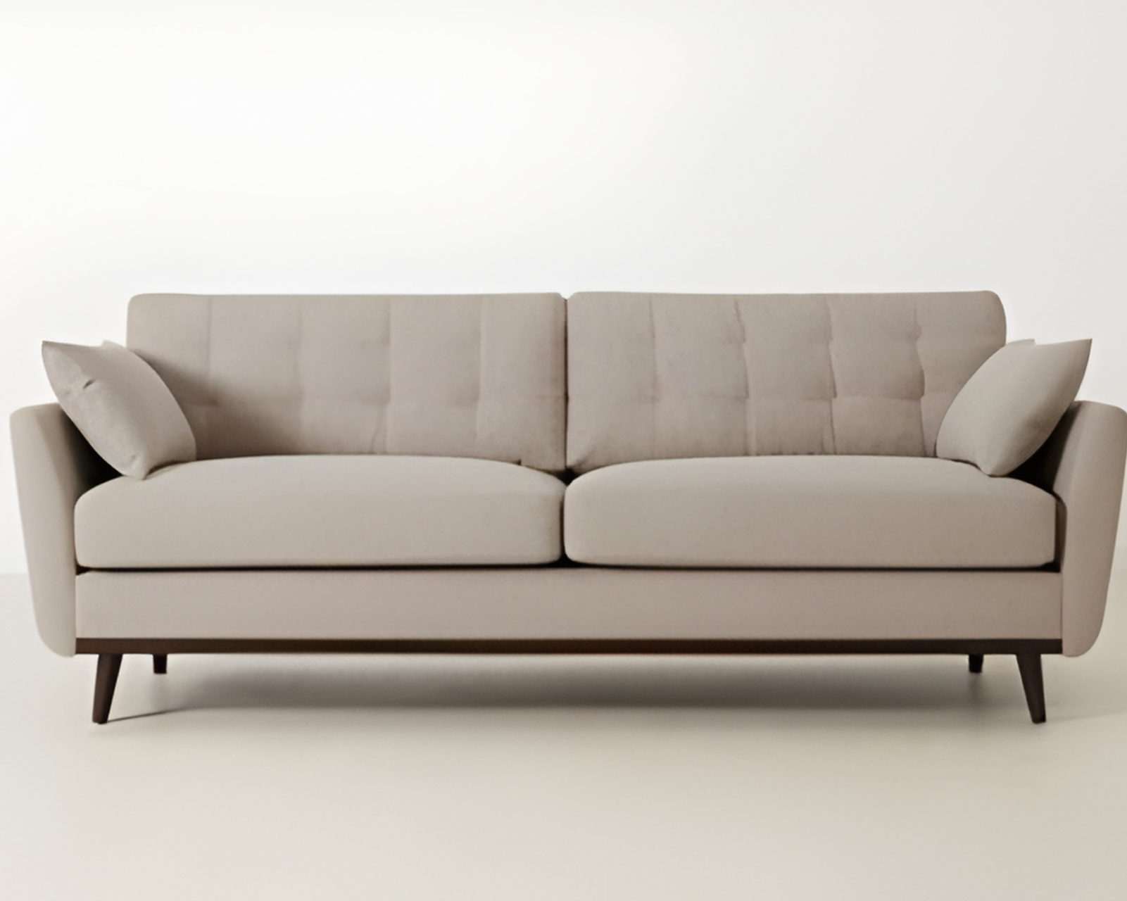 Beige sofa with two cushions on a white background